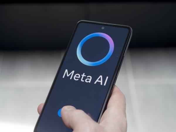 Hand holding a smartphone displaying the me<em></em>ta AI logo on June 13th 2024.
