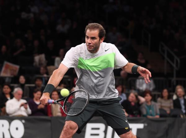 Pete Sampras hitting a return during his match against Patrick Rafter in the Powers Shares Series 2012 Nasdaq Indexes Cup