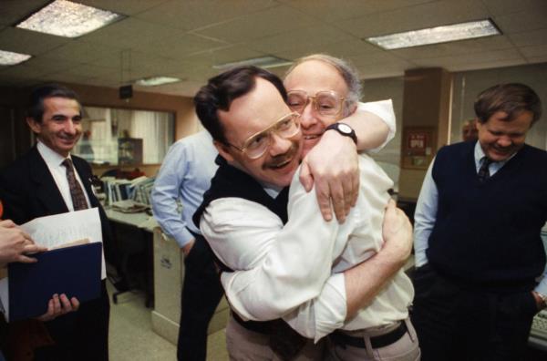 Anderson embracing his colleague Jim Abrams during his visit to the Washington bureau of the AP.
