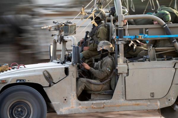Israeli soldiers are maintaining a ceasefire in Gaza during the exchange of Hamas hostages for Palestinian prisoners. 