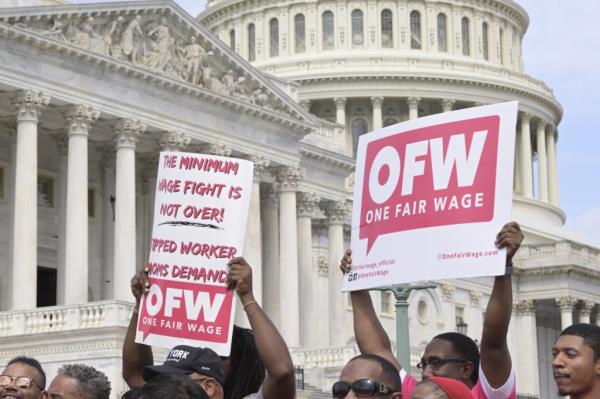 Restaurant workers holding signs during a demo<em></em>nstration for the introduction of the TIPS Act at a news conference, Washington DC, USA, September 16, 2024