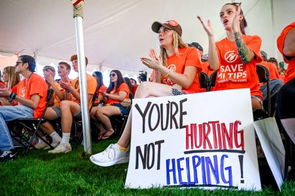 Hannah Darnell and Jesseka Brewbaker, employees of Ryan's Roadhouse, showing support at Save MI Tips rally at the Capitol in Lansing, 2024