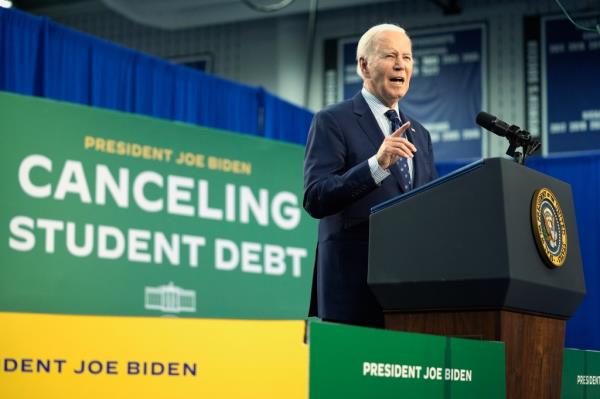 President Biden speaking at a podium a<em></em>bout student loan debt in Madison, Wisconsin, on April 8, 2024.