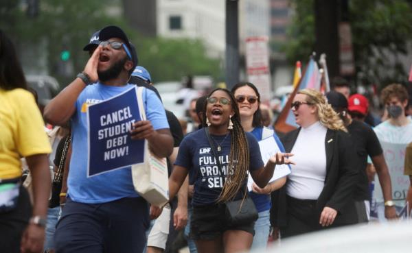 Supporters of Biden's student debt relief plan marching near the White House, Washington D.C., following a Supreme Court decision blocking the plan