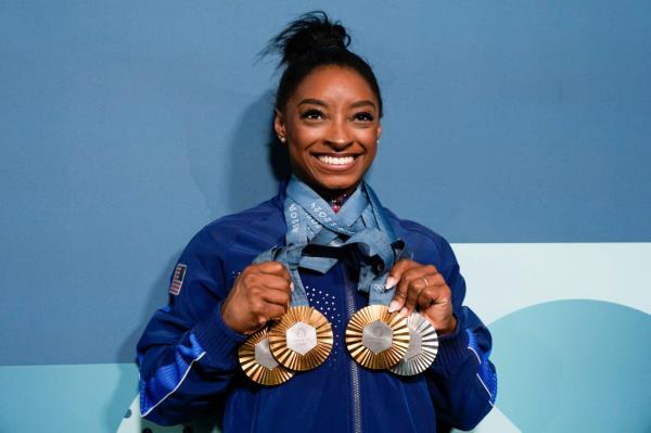 Simone Biles proudly shows off her Olympic medals from the Paris Games.