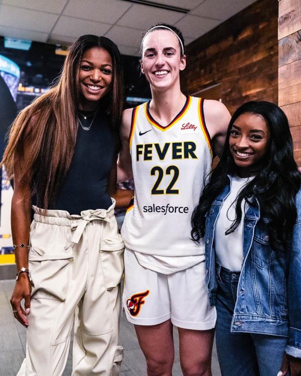 Biles (right) mingled with Caitlin Clark following her Olympics return.
