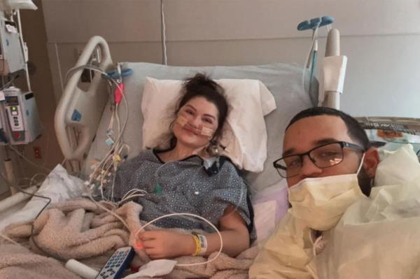 Taylor in a hospital bed with a doctor. 