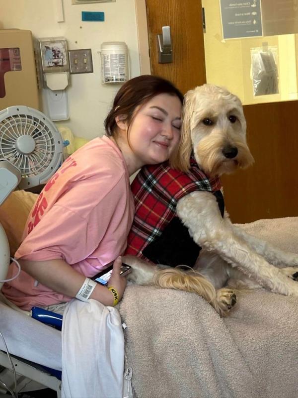Taylor with her dog in the hospital. 