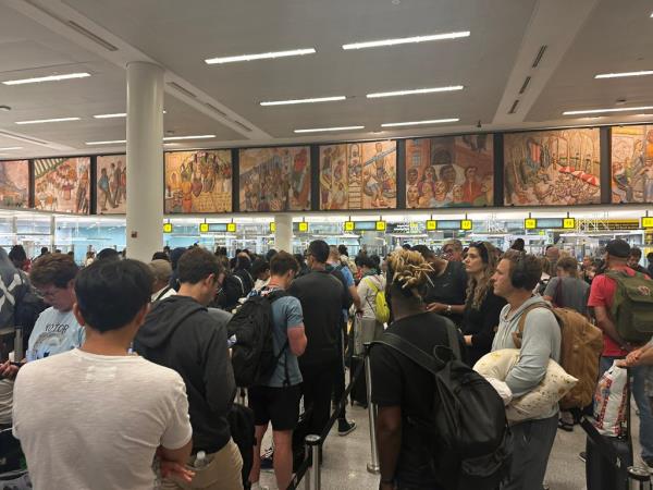 Travelers at JFK Airport faced lengthy delays over the outage. 