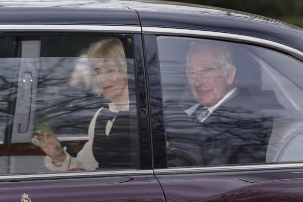 King Charles III and Queen Camilla drive away from Clarence House in London. Charles has cancer and is undergoing outpatient treatment.