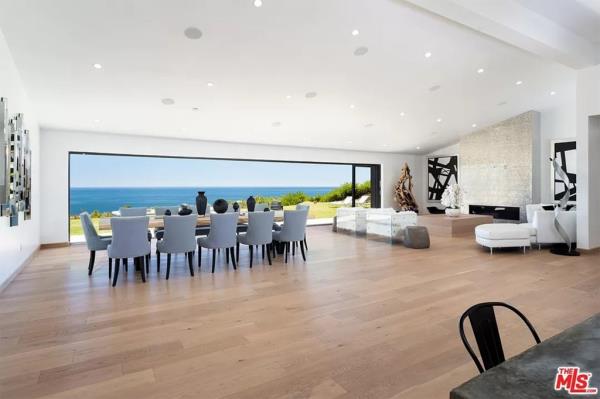  The 3,500-square-foot, midcentury modern house, located in Pacific Palisades, was bought by Perry in 2020 for $6 million and extensively renovated, featuring Batman-themed décor.