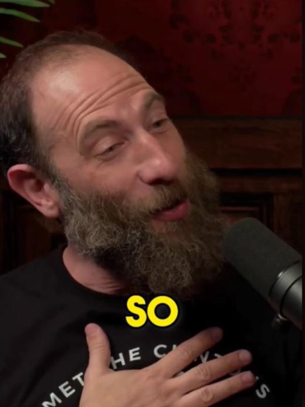 Ari Shaffir holding a microphone.