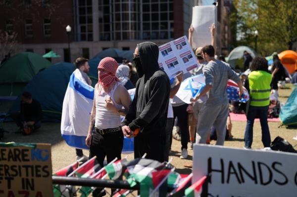 Two pro-Israel protesters stand next to each other.