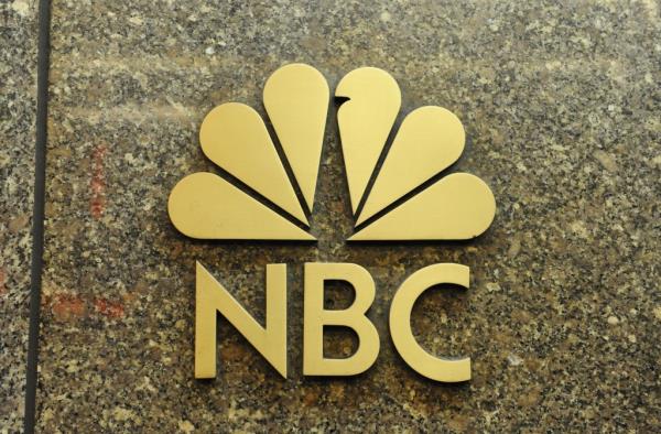 NBC peacock logo sign displayed at NBC Headquarters at 30 Rockefeller Plaza in New York, NY