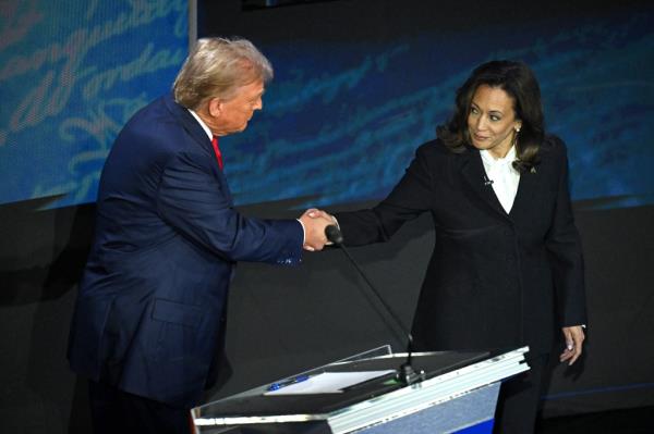 US Vice President and Democratic presidential candidate Kamala Harris (R) shakes hands with former US President and Republican presidential candidate Do<em></em>nald Trump during a presidential debate at the Natio<em></em>nal Co<em></em>nstitution Center in Philadelphia, Pennsylvania, on September 10, 2024.