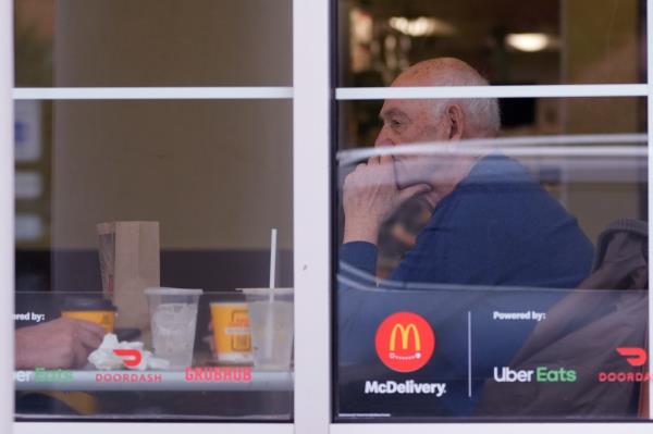 A customer sits and eats at a McDonald's in Wheeling, Ill. on March 14, 2024.