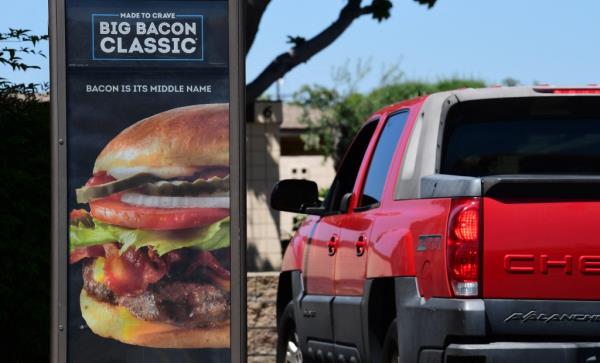 Drivers wait in line to place their orders at a drive-thru lane at a Wendy's in Alhambra, California.