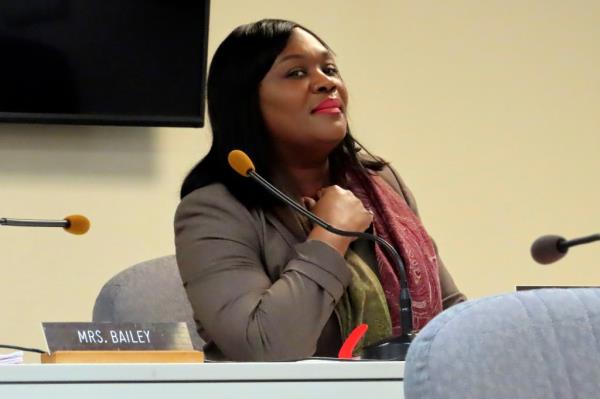 La'Quetta Small, superintendent of schools in Atlantic City, waiting to start a Board of Education meeting at a podium with a microphone