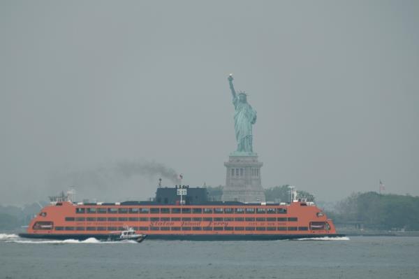 The Statue of Liberty appears in haze from Canadian wildfires on June 6, NYC's air quality is expected to be reduced Thursday.