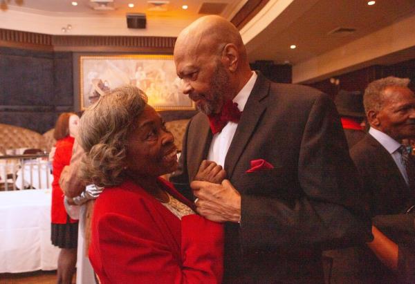 50 couples holding hands and renewing their wedding vows at Empire Steak House in Manhattan, NY.