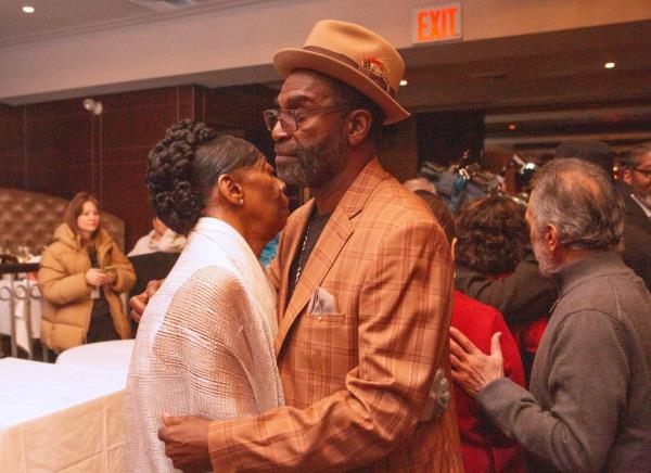 Carol and Gregory Harris kissing at vow renewal ceremony with friends and family at Empire Steak House in Manhattan on Valentine's Day 2024.