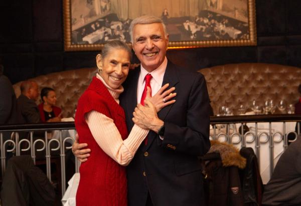 George and Elaine Templeton embracing each other during their wedding vow renewal ceremony at Empire Steak House in Manhattan.