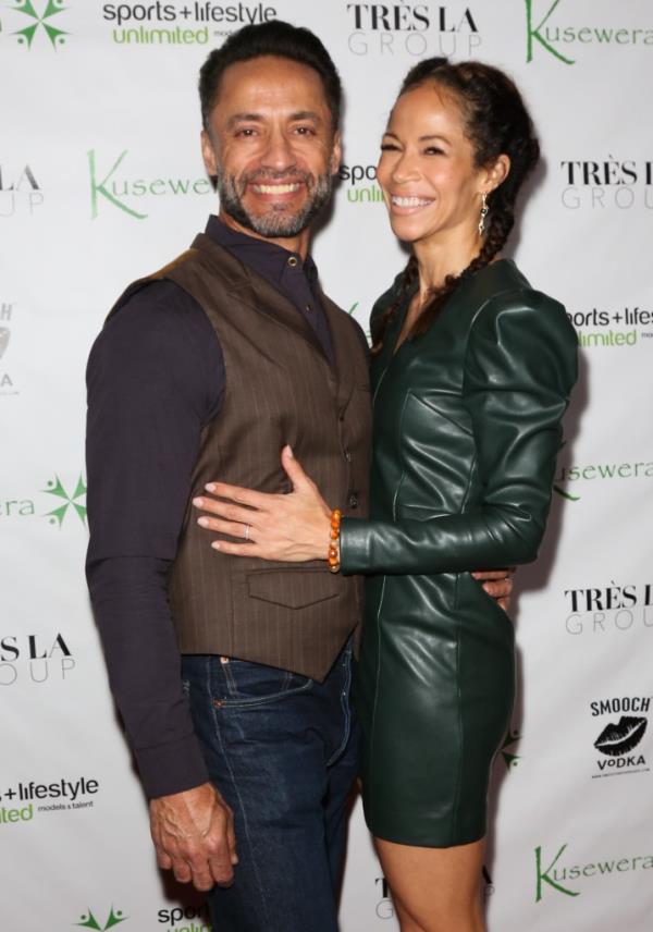  Kamar de los Reyes with his wife, Sherri Saum, smiling. 