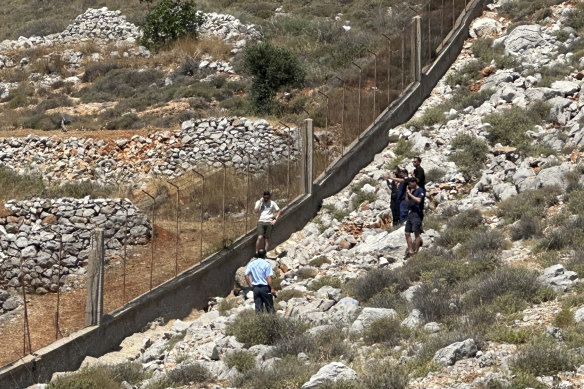 Firemen and policemen surround the spot wher<em></em>e Mosley was found.