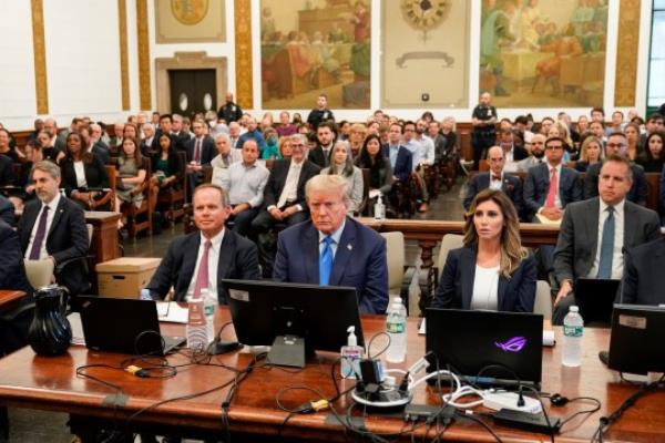 Former President Do<em></em>nald Trump, center, sits in the courtroom at New York Supreme Court, Monday, Oct. 2, 2023, in New York. Trump is making a rare, voluntary trip to court in New York for the start of a civil trial in a lawsuit that already has resulted in a judge ruling that he committed fraud in his business dealings. (AP Photo/Seth Wenig)