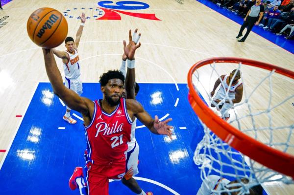 Philadelphia 76ers' Joel Embiid goes up for the dunk during the second half of an NBA basketball game against the Phoenix Suns, Tuesday, Feb. 8, 2022, in Philadelphia.
