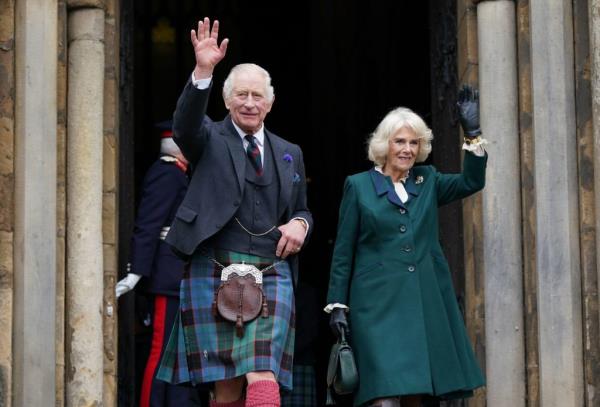 King Charles III and Camilla, Queen Consort, waving to o<em></em>nlookers as they leave Dunfermline Abbey in Scotland