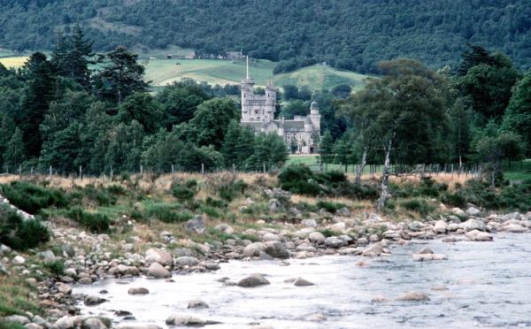 HRH Prince Charles and The Duchess of Cornwall during their ho<em></em>neymoon at Balmoral Estates, with a castle near a river in the background