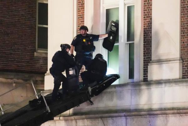New York City police officers use a ramp on an armored vehicle to enter Hamilton Hall at Columbia University.