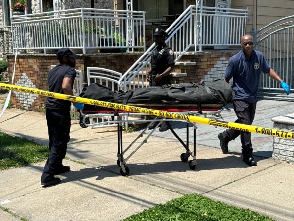 Authorities pull the body from the Cavak house. 