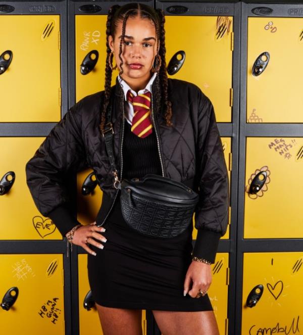 Tillie Amartey posing in front of lockers as Stacey 'Stace' Neville