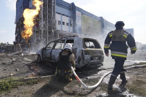 Firefighters extinguish the fire after a Russian missile attack in Kharkiv, Ukraine, on Sunday.