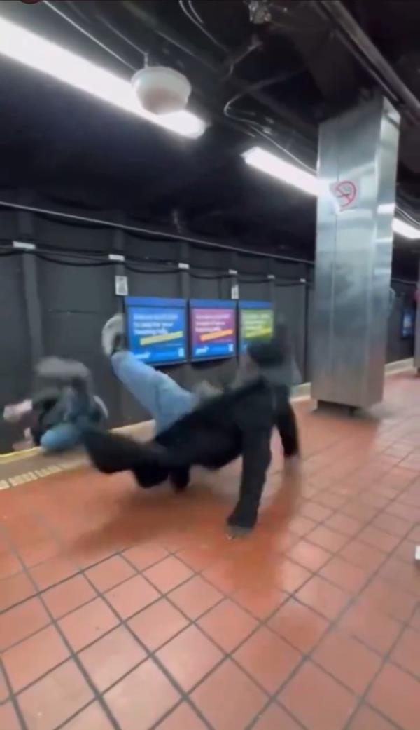 The man is seen fall on to the tracks after being punched.