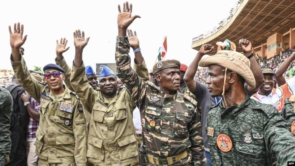 FILE - Nigerien military leaders wave to supporters at the General Seyni Kountche Stadium in Niamey, Niger, on Aug. 26, 2023. 