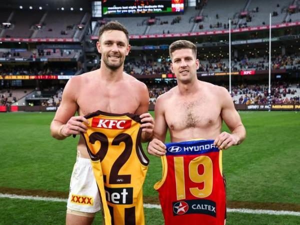 Luke Breust and Jack Gunston swap jumpers.