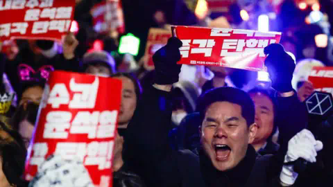 Getty Images People take part in a rally featuring K-POP musics to protest against South Korean Yoon Suk Yeol, after the parliament passed a bill to appoint a special counsel to investigate Yoon over his failed attempt to impose martial law, near the Natio<em></em>nal Assembly, in Seoul, South Korea, on 10 December, 2024. 